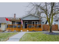 Charming home with a covered front porch, wooden railings, and decorative touches at 6047 Guilford Ave, Indianapolis, IN 46220