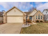 Charming single-Gathering home featuring a two-car garage, brick accents, and well-manicured landscaping at 6432 Hunters Green Ct, Indianapolis, IN 46278