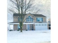 Two-story home with brick facade, attached two-car garage, and a snow-covered front yard at 739 Quarterhorse Run, Bargersville, IN 46106