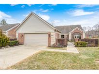 Charming brick home with a two-car garage, manicured landscaping, and inviting curb appeal at 8545 Olde Ml Trce, Indianapolis, IN 46260