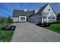 Charming home with stone accents, manicured lawn, and a spacious driveway at 10297 Anees Ln, Fishers, IN 46040