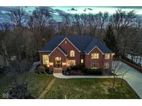 Stunning two-story brick home with lush landscaping and a welcoming front entrance at 11727 Windpointe Pass, Carmel, IN 46033