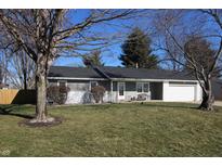 Charming ranch-style home featuring a well-maintained lawn and attached two-car garage at 5478 E Broadmore Dr, Columbus, IN 47201