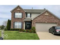 Charming two-story brick home with attached two-car garage and well-manicured lawn at 7438 Jack Pine Ct, Avon, IN 46123