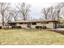 Charming single-story home with well-maintained landscaping, and a cozy, inviting facade at 845 E 81St St, Indianapolis, IN 46240
