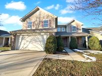 Charming two-story home featuring attached two car garage, manicured shrubs and attractive curb appeal at 11322 Pegasus Dr, Noblesville, IN 46060
