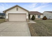 Charming single-story home featuring a beige exterior, attached garage, and well-maintained lawn at 1518 Prairie Depot, Indianapolis, IN 46241