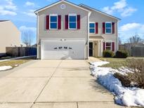 Charming two-story home with a well-maintained lawn and a two car garage at 1829 Blackmore Dr, Indianapolis, IN 46231