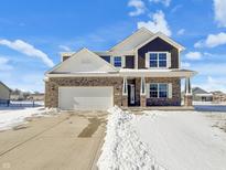 Beautiful two-story home featuring a brick and dark brown exterior and an attached two-car garage at 202 Larimar Dr, Whiteland, IN 46184
