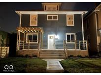 Charming two-story home with a welcoming front porch, and steps leading to the front door at 3357 N Kenwood Ave, Indianapolis, IN 46208