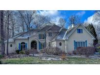 Charming two-story brick home with bright blue shutters and a well-manicured front yard on a sunny day at 4388 Creekside Pass, Zionsville, IN 46077