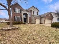 Two-story brick and siding home with a three-car garage and a well-manicured front lawn at 516 Homestead Ln, Greenwood, IN 46142