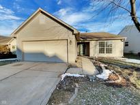 Charming one-story home featuring a manicured lawn, two car garage, and inviting entrance at 5251 Rocky Mountain Dr, Indianapolis, IN 46237