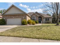Charming brick home featuring a two-car garage and well-maintained landscaping at 6049 Boulder Ct, Columbus, IN 47201
