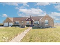 Charming single-story home with a windmill and a well-manicured front lawn and stone accents at 7705 N State Road 42, Stilesville, IN 46180