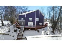 Stunning exterior view of a two-story home with a large deck and snowy yard at 815 Woodhill Dr, Indianapolis, IN 46227