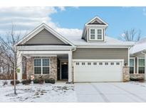 Charming home featuring gray siding, brick accents, a two-car garage, and a dormer on the roof at 10178 Bolcom Ct, Noblesville, IN 46060