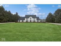 Stunning two-story home with black trim, a vast lawn, mature trees, and plenty of curb appeal at 11120 Queens Way Cir, Carmel, IN 46032