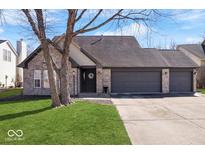 Charming brick home with a well-maintained lawn and an attached three-car garage at 14479 Dublin Dr, Carmel, IN 46033