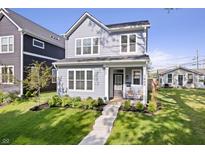 Charming two-story home features a well-maintained front yard, inviting entrance, and classic architectural details at 1842 Milburn St, Indianapolis, IN 46202
