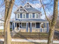 Charming two-story home with a covered front porch and inviting curb appeal at 201 N Tacoma Ave, Indianapolis, IN 46201