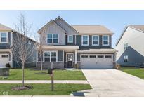 Charming two-story home with a well-manicured lawn and a two-car garage at 20106 Edwick Dr, Westfield, IN 46074