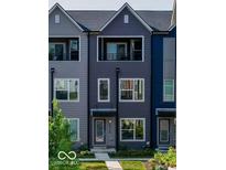 Charming three-story townhouse featuring a private balcony, modern facade, and inviting entrance at 2139 Coretta Way, Indianapolis, IN 46202