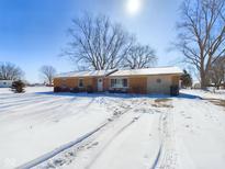Charming single-story home featuring a brick facade and snowy front yard at 2749 W 900 S, Pendleton, IN 46064