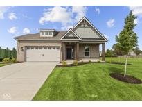 Charming single-story home with brick facade, attached garage, and manicured lawn at 5040 Carmine St, Brownsburg, IN 46112