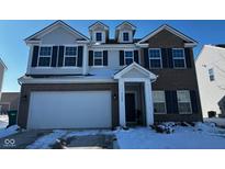 Charming two-story home with a two-car garage, brick facade, and dormer windows at 5120 Maywood Dr, Whitestown, IN 46075