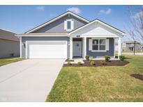 Charming home featuring a well-maintained lawn, gray siding, and a spacious two-car garage at 5146 Cartland Dr, Indianapolis, IN 46239