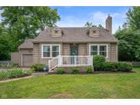 Charming home featuring a well-manicured lawn, neutral siding, and inviting front porch at 6865 Meadow View Dr, Lawrence, IN 46226
