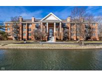 An inviting brick condo with balconies, columns, and waterfront views at 8690 Jaffa Ct W Dr # 18, Indianapolis, IN 46260