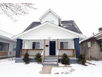 Charming home featuring a covered front porch, white siding, and black roof, perfect for curb appeal at 949 N Warman Ave, Indianapolis, IN 46222