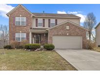 Charming brick and vinyl two-story home with attached two car garage and well maintained lawn at 10315 Gladeview Dr, Indianapolis, IN 46239