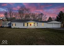 Charming single-story home featuring a well-maintained lawn and an attached two-car garage at 1408 W Banta Rd, Indianapolis, IN 46217