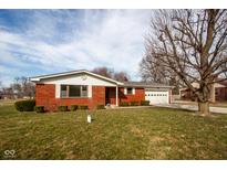 Charming brick ranch home featuring an attached garage and well-maintained front yard at 2566 S Ritter Ave, Indianapolis, IN 46203