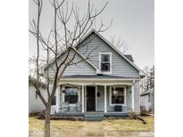 Charming home featuring a covered front porch, neutral siding, and inviting curb appeal at 2962 Station St, Indianapolis, IN 46218