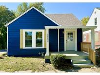 Charming blue home featuring a covered front porch and manicured landscaping at 3452 N Bancroft St, Indianapolis, IN 46218