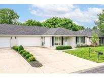 Charming brick home with an attached two-car garage, driveway, manicured lawn and landscaping at 4501 N Wheeling Ave # 10A-101, Muncie, IN 47304