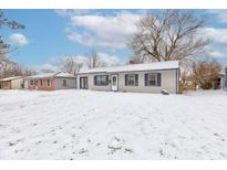 Single-story home with neutral siding and classic shutters, complemented by a snow-covered front yard and winter sky at 61 North Dr, Mooresville, IN 46158