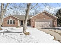 Charming brick home with a two-car garage and inviting front entrance partially covered in snow at 771 Cheeseman Ave, Danville, IN 46122