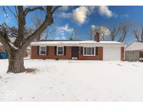 Charming single-story brick home featuring a well-maintained front yard and attached one car garage at 7909 Cullen Dr, Indianapolis, IN 46219