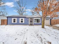 Charming one-story home with a metal roof, an attached garage, and a snow-covered front yard at 930 Edgewood Dr, Mooresville, IN 46158
