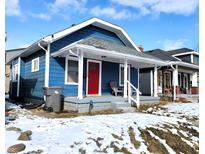 Charming blue home with a bright red door and covered front porch, perfect for enjoying the neighborhood view at 1328 E Minnesota St, Indianapolis, IN 46203