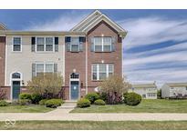 Charming brick and siding townhouse with well-manicured lawn and landscaping at 14026 E End Rd, Fishers, IN 46037