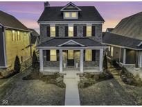 Charming two-story brick home with a welcoming front porch and manicured lawn at 1538 Cloverdon Dr, Westfield, IN 46074