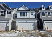 New construction two-story home featuring white siding, a two-car garage, and black roof accents against a blue sky at 18712 Moray St, Westfield, IN 46074