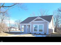 Charming single Gathering home featuring classic architecture, neutral siding, and crisp white trim at 1967 Hovey St, Indianapolis, IN 46218
