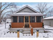 Charming bungalow featuring a cozy screened front porch and meticulous landscaping at 2337 Collier St, Indianapolis, IN 46241